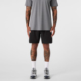 Black sports shorts are displayed, paired with a grey t-shirt and athletic shoes, featuring a logo.