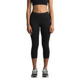 A pair of black mid-length leggings, featuring a fitted design and a subtle logo, worn with athletic shoes.