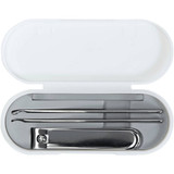 A white manicure set case containing metal tools including a nail clipper and two cuticle pushers.