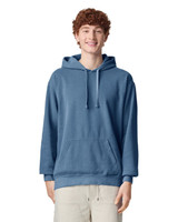 A blue adult hooded sweatshirt featuring a front pouch pocket and a logo, worn by a smiling model.