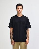 A dark navy heavyweight t-shirt displayed on a model, featuring a simple design and a logo.