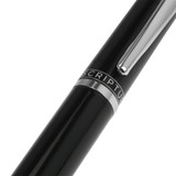 A black metal ballpoint pen with a silver clip and branding detail.