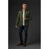 A man models a men's quilted jacket in olive green, paired with a light top, jeans, and boots. The jacket has a logo.