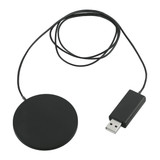 A round, black wireless charging pad with a USB cable attached. It features a streamlined, thin design.