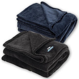 A folded coral fleece blanket in navy blue and a second in charcoal grey, both with a logo.