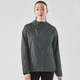 A women's wind jacket in dark grey with a hood and a logo, featuring a lightweight design and long sleeves.