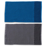 Two gym towels displayed, one in blue with a patterned design and the other in grey with a similar pattern, both featuring a pocket.