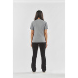 A woman stands with her back to the camera, wearing a grey Women's Volante H2X-Dry Tee and black pants.