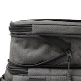A grey expanding cooler with zippers and compartments for storage. Features a sleek, modern design.