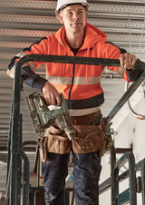 A unisex hi-vis full zip stretch taped hoodie in orange, worn by a person on a work platform, holding a power drill.