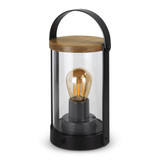 A black lantern with a glass body and wooden top, featuring a vintage-style bulb inside.