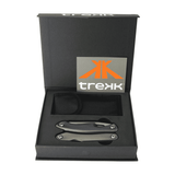 A multi-tool with a sleek metallic finish, presented in a black box with a logo. Includes a storage pouch.