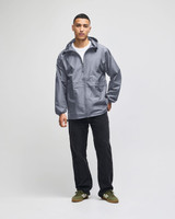 A full-zip, grey anorak jacket with a hood, featuring a front pocket and a branded logo.