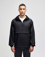 A black packable anorak jacket with a hood, featuring a front zip and a logo. Model is standing against a plain background.