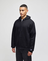 A black full-zip hooded sweatshirt featuring a logo, shown on a model standing straight.