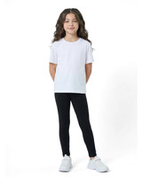 A child wearing black leggings paired with a plain white T-shirt and white sneakers, smiling confidently.