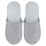 Felt slippers in light grey with a simple design and soft texture, featuring a logo on one slipper.