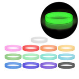 A collection of silicone wristbands in various colours, including a glowing green one, with a logo on some bands.