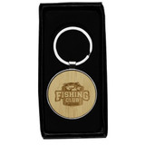 A circular keyring made of recycled zinc alloy with a bamboo disc, presented in a black box.