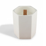 A white hexagonal ceramic candle with a wooden wick placed inside. It has a minimalist design.