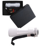 A silver flashlight in a black box, accompanied by batteries and featuring a strap for easy carrying.