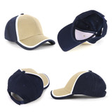 A cap featuring a navy blue and tan design with white double trim and a logo on the front.