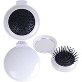 A compact pop-up brush and mirror set in white, featuring a brush with black bristles and a round mirror.