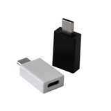 A black and a white Type-C adapter, designed for connecting devices. Both have a rectangular shape with rounded edges.