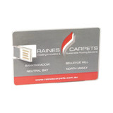 An acrylic flash drive designed like a credit card, featuring a logo and various locations. Dominant colours are silver and red.