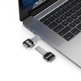 A silver Auto LED flash drive plugged into a laptop, featuring a sleek design and a logo.