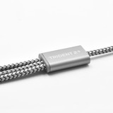 A grey and silver charging cable with a braided design, featuring branding on the connector.