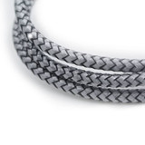 A braided charging cable in grey, featuring an eco-friendly design and a logo.