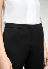 Black women's slacks feature a sleek design, shown with a light-coloured shirt. The waistband is smooth and tailored.