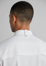 A white short sleeve chef jacket with a stand collar and a back neck tab, showcasing the garment's design.