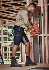 Men's Streetworx Stretch Shorts in navy with grey accents, worn by a man using a nail gun in a construction setting.