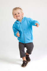 A blue zip hoodie for babies, featuring a front zip and a hood, worn by a smiling child in casual pants and shoes.