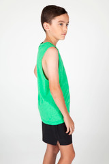 A green tank top is worn by a boy, featuring a sleeveless design and paired with black shorts.