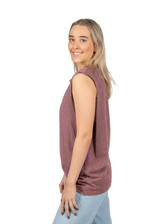 A woman models a stone-washed tank top in a soft mauve hue, featuring a relaxed fit and sleeveless design.
