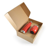 A red drink bottle and a red tumbler inside a cardboard gift box with an open lid. The box has a logo.