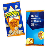 Two packets of microwave popcorn. One is brightly coloured blue and yellow with a butter flavour, while the other is blue with a logo.