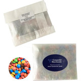 A kraft paper bag containing mixed M&Ms in various colours, featuring a logo on the packaging.