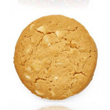 A round, golden-brown cookie featuring white chocolate and macadamia nuts, with a crumbly texture.