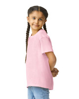 A pink Gildan Youth Softstyle short sleeve T-shirt displayed on a young girl, who has braided hair and is smiling.
