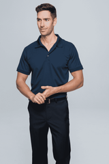 A navy polo shirt worn by a man, paired with black trousers. The shirt features a collar and a logo.