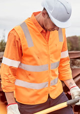 A high visibility orange zip vest with reflective stripes worn by a person in work attire.