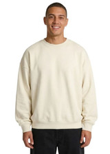 A beige oversize crew neck fleece jumper featuring dropped shoulders and a relaxed fit. It includes a logo on the label.