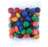 A clear bag filled with a variety of colorful M&M's, including red, blue, green, yellow, orange, and black candies.