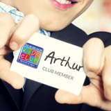 A person holding a membership card with a logo, featuring the name "Arthur" and the text "Club Member" on a white background.