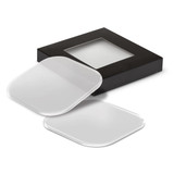 A set of clear coasters with rounded edges, displayed in a black box with a transparent window.