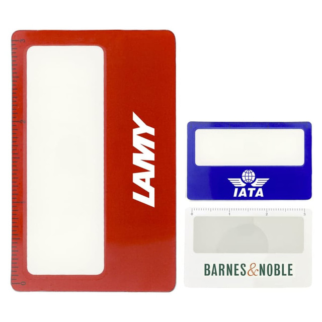 A red pocket ruler magnifier with a white magnifying area and a logo, accompanied by two smaller rulers in blue and white.